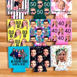 May include: A set of six personalized can coolers with various designs and text. The designs include a tropical scene with flamingos, a green background with the number 50, a tie-dye pattern with a baby's face, a pink background with the number 40, a blue background with the text "#ASHBASH ASPEN, 2020", and a black and white pattern with a person's face.