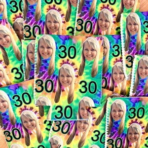 May include: A close-up of a pile of colorful can coolers with a tie-dye pattern and the number 30 printed on them. The coolers are made of neoprene and have a sewn edge.