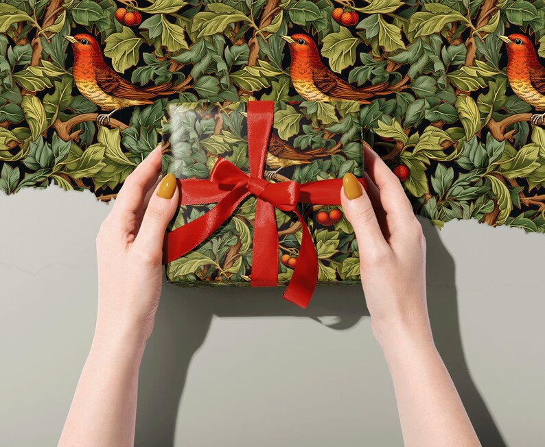 Holiday Wrapping Paper: Holly, Ivy, and Robin Pattern around a gift with a ribbon held in two hands