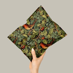 Holiday Wrapping Paper: Holly, Ivy, and Robin Pattern around a gift withblack string