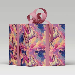 Magical White Flying Unicorn Gift Wrap with Rainbow Clouds and Stars around a parcel with pink ribbon