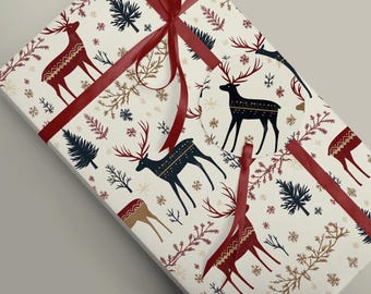 May include: A wrapped gift box with a festive holiday design. The wrapping paper features a cream background with repeating patterns of reindeer, snowflakes, and evergreen branches in red, navy, and gold. A red ribbon is tied around the box.
