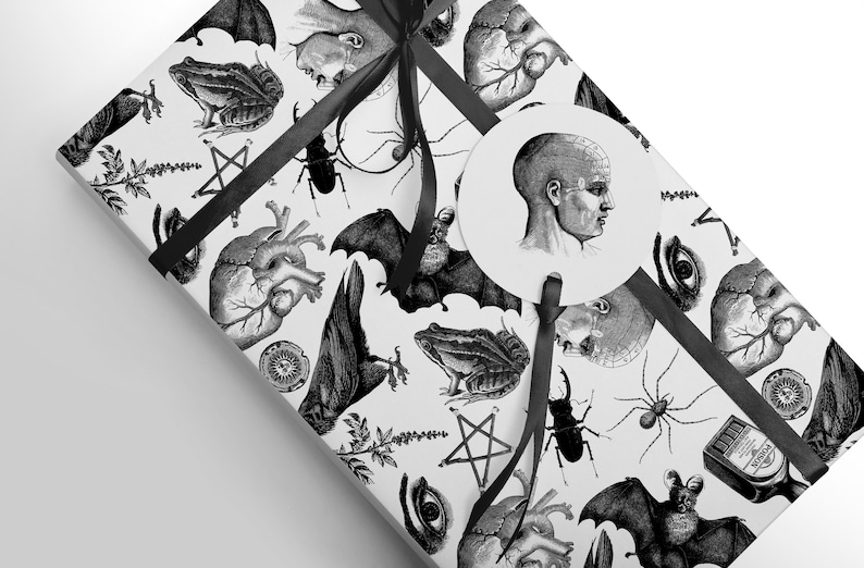 Monochrome witch craft artwork on wrapping paper, a box with a black ribbon