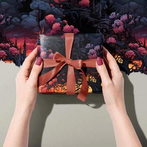 Wrapping paper with a surreal flower, tree and cloud image, wrapping a gift with a dusky pink ribbon, held in two hands.