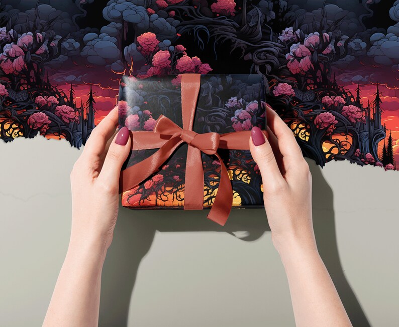 Wrapping paper with a surreal flower, tree and cloud image, wrapping a gift with a dusky pink ribbon, held in two hands.