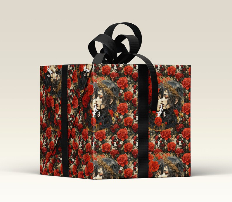 May include: A black gift box with a black ribbon and a floral pattern. The pattern features red roses and a repeated image of two women with long dark hair.