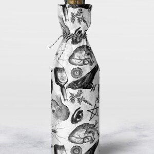 Monochrome witch craft artwork on tissue paper wrapping a bottle