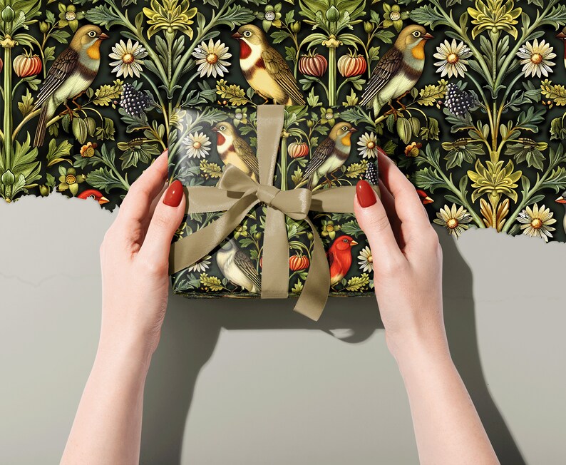 May include: A gift box wrapped in green and black patterned paper featuring birds and flowers. The paper has a vintage aesthetic.