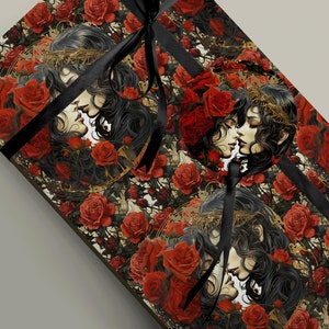 May include: A black and gold gift wrap with a repeating pattern of two women with long black hair kissing, surrounded by red roses and vines.