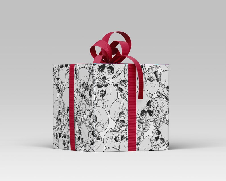 Wrapping paper featuring skulls shown wrapping a gift with gift tag and red ribbon.