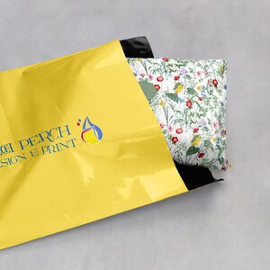 Wildflower tissue paper covering a gift being put into a yellow postage bag