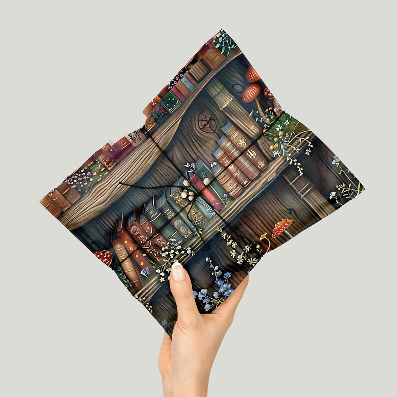 May include: A decorative cushion with a detailed illustration of a bookshelf filled with antique books, mushrooms, and flowers. The cushion has a dark, moody colour palette with shades of brown, green, and red. The design evokes a whimsical, fantasy theme.