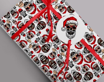 May include: White wrapping paper with a repeating pattern of Santa Claus skulls wearing sunglasses and a red Santa hat. The paper is tied with a red ribbon and has a round sticker with a Santa Claus skull wearing sunglasses and a red Santa hat.