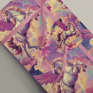 Magical White Flying Unicorn Gift Wrap with Rainbow Clouds and Stars around a parcel with pink ribbon