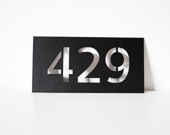 May include: A black card with the number 429 cut out of it, revealing a white background.