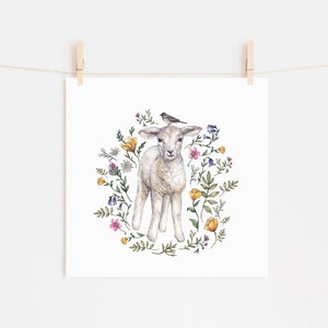 May include: A watercolor painting of a white lamb standing in a circle of colorful wildflowers. A small bird sits on the lamb's head.