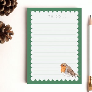 May include: Green notepad with a scalloped edge and lined paper. The notepad has the words "TO DO..." printed at the top. A robin illustration is at the bottom of the notepad.