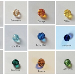 May include: Assortment of 16 round glass beads in various colors, including clear, champagne, orange, yellow, red, gray, light blue, royal blue, navy blue, teal, purple, dark green, brown, light green, and black.