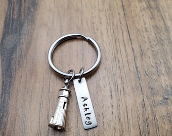 May include: Silver keychain with a lighthouse charm and a personalized tag that says "Ashley".
