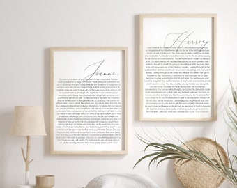 May include: Two framed prints with black text on a white background. The text is a love letter to a partner. The left print says "Joanne" and the right print says "Harvey". The prints are hanging on a wall above a wooden bench with a white throw pillow and two woven baskets.