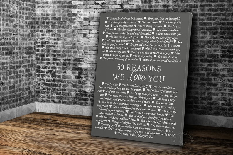 May include: A gray and white sign with the text "50 Reasons We Love You" and a list of 50 reasons written in white text with hearts.