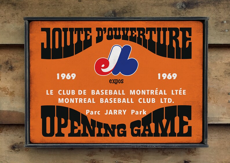 May include: A vintage orange and black sign with the text "JOUTE D'OUVERTURE" and "OPENING GAME". The sign also features the Montreal Expos logo and the years "1969" and "1969".