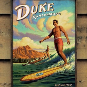 May include: A vintage-style poster featuring Duke Kahanamoku, a Hawaiian surfer, riding a wave on a surfboard. The poster has a blue and green background with a mountain in the distance. The text "DUKE KAHANAMOKU" is at the top of the poster, and the text "SURFING LEGEND OLYMPIC CHAMPION" is at the bottom.