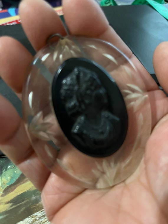 Vintage clear & black lucite cameo mounted on top