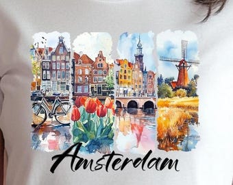 May include: A white t-shirt featuring a watercolour illustration of Amsterdam. The illustration depicts a canal with bridges, buildings, a windmill, and tulips. The text "Amsterdam" is printed below the illustration.