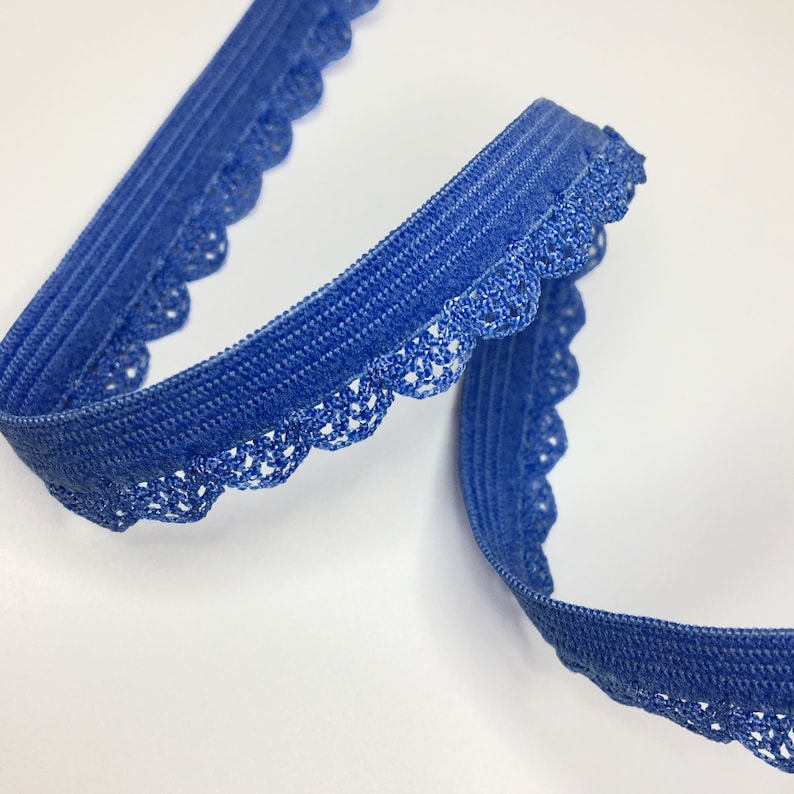 May include: Blue elastic trim with a scalloped lace edge. The trim is approximately 1 inch wide.