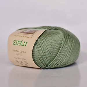 May include: A ball of green 100% Pima cotton yarn called "Sip&aacute;n" by Peruvian Fibers. The label indicates it is combed and has 50 grams, 169 meters, and 185 yards.