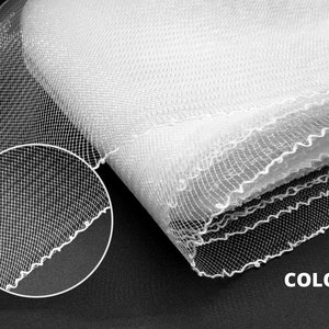 May include: White tulle fabric with a scalloped edge. The fabric is folded in half and the texture of the mesh is visible. 1 COLOR