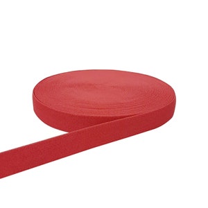 May include: A roll of red elastic fabric, ideal for sewing projects.