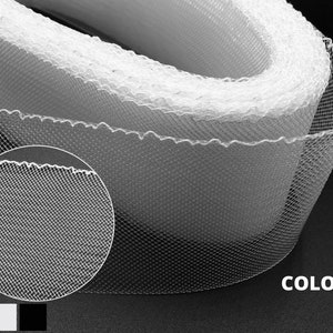 May include: White tulle trim with a scalloped edge. The trim is made of a fine mesh fabric and is perfect for adding a touch of elegance to any project. 3 Colors.