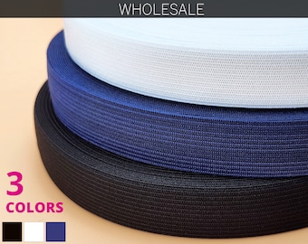 May include: Three rolls of elastic ribbon in black, white, and navy blue. The word "WHOLESALE" is at the top of the image. The text "3 COLORS" is in pink, with color swatches below.