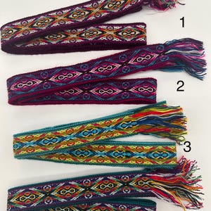 May include: Four woven fabric bands with colorful geometric patterns and fringe ends. The bands are numbered 1 through 4.