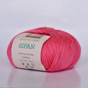 May include: A ball of pink 100% Pima cotton yarn called "Sip&aacute;n" by Peruvian Fibers. The label indicates it is combed, 50 grams, 169 meters, and 185 yards.