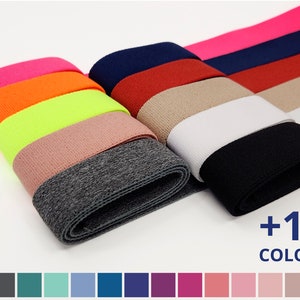 May include: A variety of colours of elastic fabric, including pink, orange, yellow, green, brown, grey, white, black, red, and blue. The fabric is shown in a pile, with the colours arranged in a rainbow pattern. The text +19 COLOURS is shown at the bottom of the image. A colour chart with 19 different colours is shown at the bottom of the image.