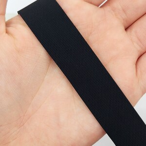 May include: Black elastic band with a textured surface.