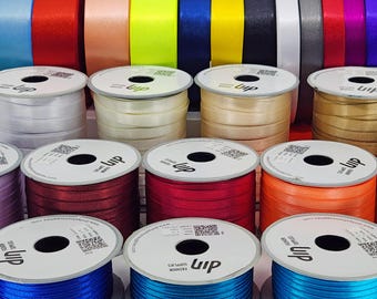 May include: Assortment of spools of satin ribbon in various colors, including blue, red, orange, yellow, green, purple, and white. The spools are labeled with the word "LUP" and a QR code.