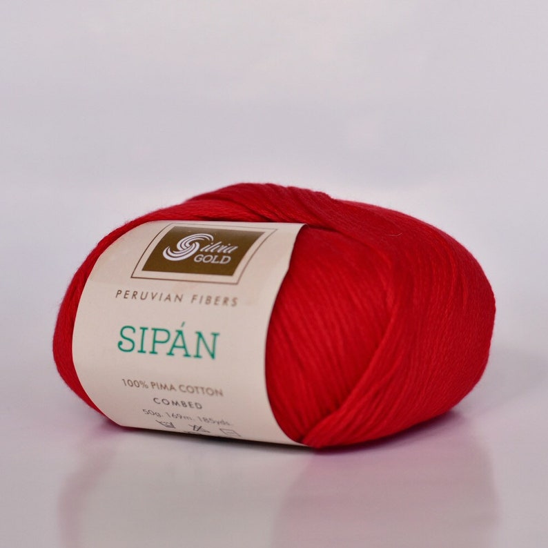 May include: A ball of red 100% Pima cotton yarn labeled "Sipán Peruvian Fibers" with the brand name "Seda Gold" on the label.