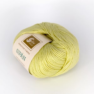 May include: A ball of pale yellow yarn with a label that reads "Peruvian Fibers Sip&aacute;n 100% Pima Cotton" and a logo that says "Slivia Gold".