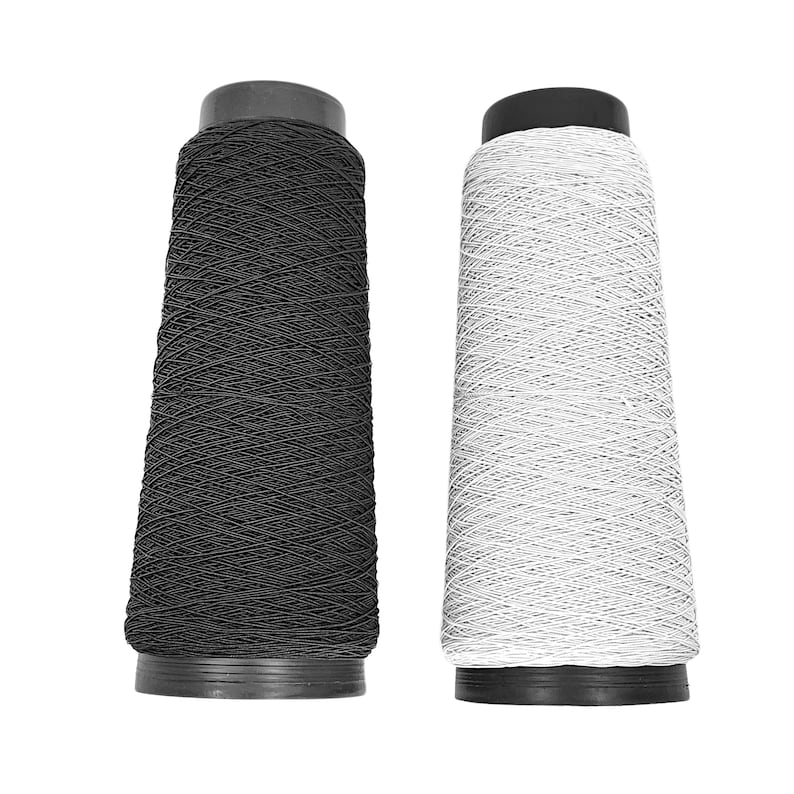 May include: Two spools of elastic thread, one black and one white. The spools are made of plastic and have a black top.