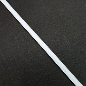 May include: A white, thin, straight line against a black background.