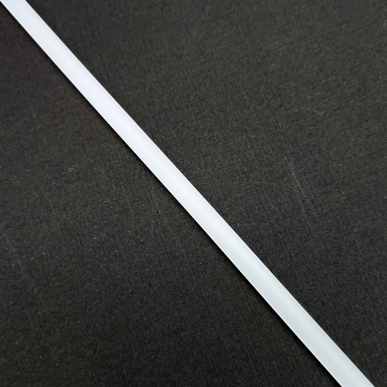May include: A white, thin, straight line against a black background.