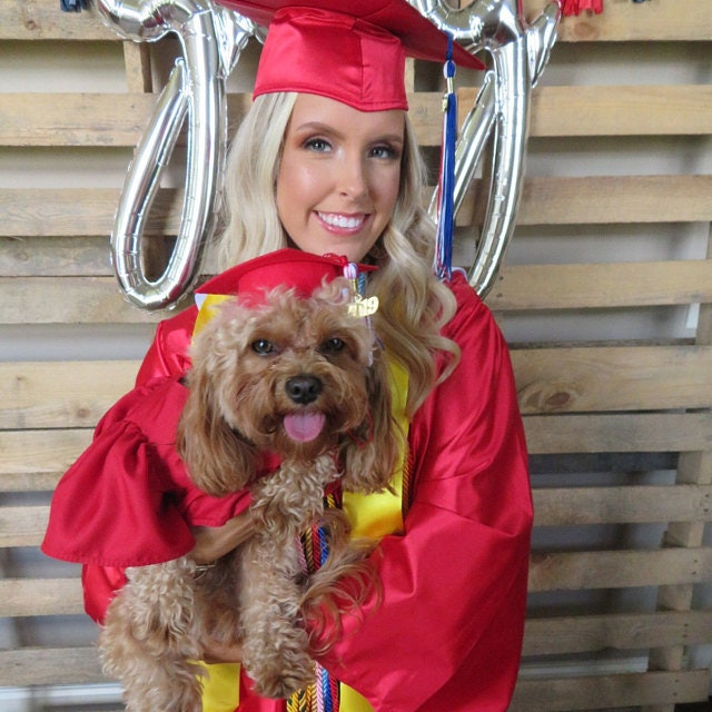 Female Graduates In Red Gown And White Streamers Custom Graduation