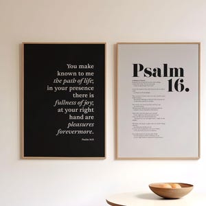 May include: Two framed prints with black text on a white background. The left print features a quote from Psalm 16:11. The right print features the text "Psalm 16."