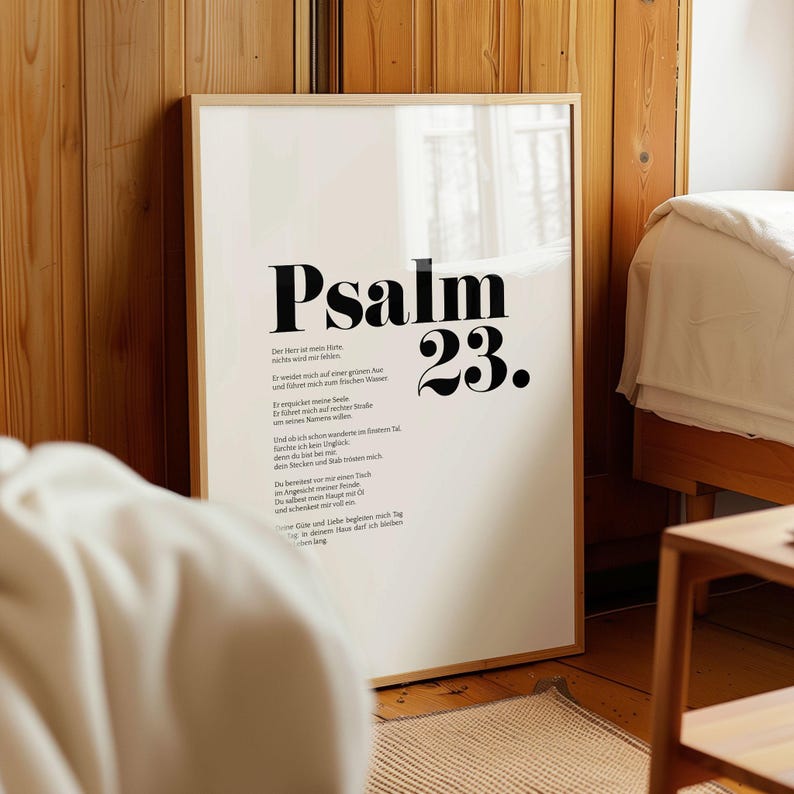 May include: A framed print with a white background and black text. The text reads "Psalm 23." and includes a German translation of the Psalm. The frame is a light wood color.