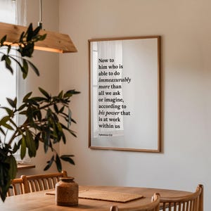 Puede incluir: Una impresión enmarcada con fondo blanco y texto negro. El texto dice "Now to him who is able to do immeasurably more than all we ask or imagine, according to his power that is at work within us Ephesians 2:20".