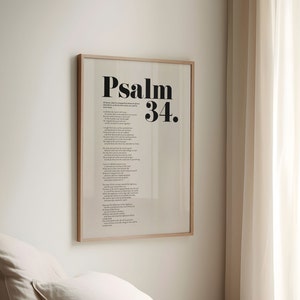 May include: A framed print with the text "Psalm 34." in black bold font. The print is on a white background and is framed in a light wood frame.